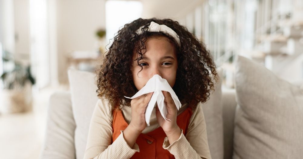 child blowing nose.