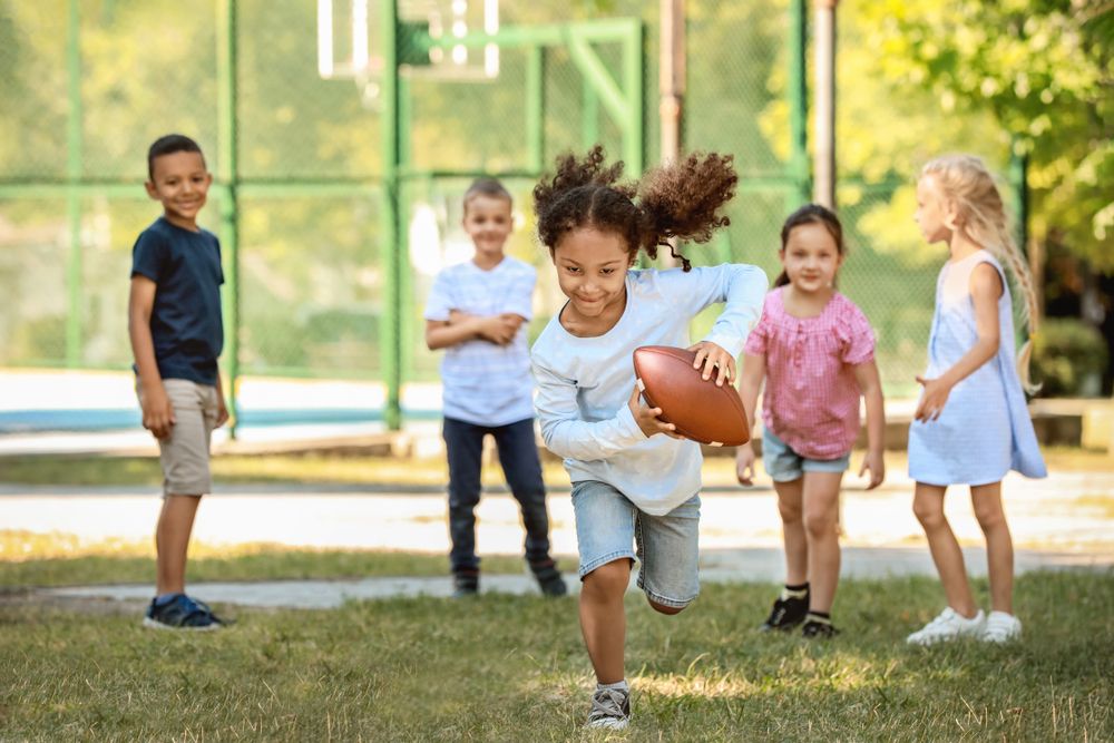 kids playing football in the spring.